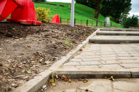 poorly executed road repairs. replacing the old curb stone with a new one. road work have bad qualityの写真素材