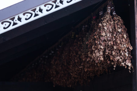 Dried leaves hanging from the roof of a shop in the city