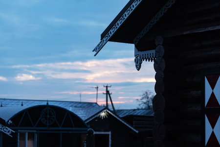 Wooden house in the village against the background of the evening sky