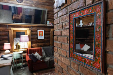 Interior of a room with a fireplace and a picture on the wallの写真素材