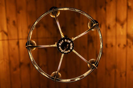 Luxury chandelier hanging on wooden wall, closeupの写真素材