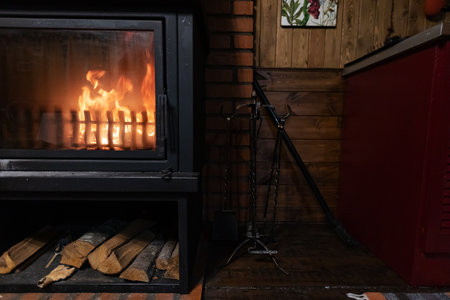 Fireplace in a country house on a wooden floor with firewoodの写真素材