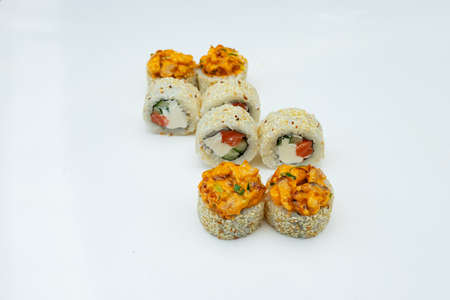 a portion of sushi rolls with sweet and sour sauce is on the white table, a dish of Asian cuisine from rice and seafood for eating in the restaurantの写真素材