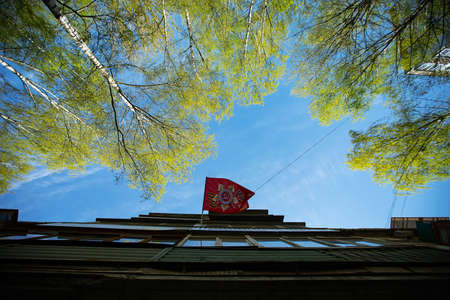 A view of a flag on the top of the building.の写真素材
