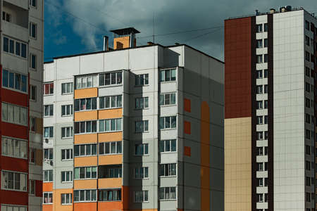 Modern multi-storey residential building on a background of blue skyの写真素材