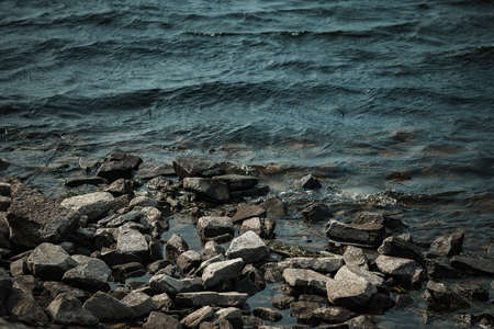Rocks on the shore of the lake. Close-up photo.の写真素材