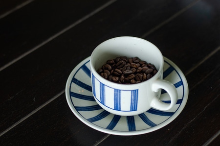 Coffee cup with good quality coffee beans insideの写真素材