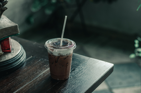 A glass of cold cocoa is located on a table in one cafe.の写真素材