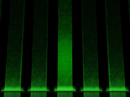 Colonnade of the vertical columns illuminated greenの写真素材