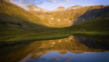 Mountain reflection in the lake at sunsetの写真素材
