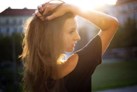 Beautiful girl portrait on a warm sunny eveningの写真素材