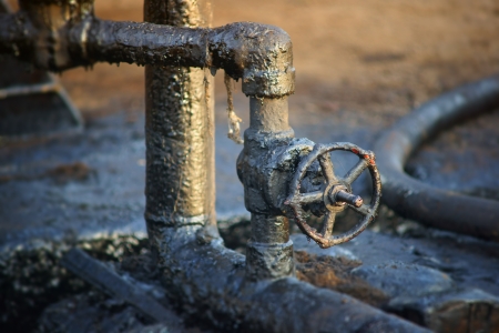 Detail of a dirty pipes and a valve from oil refinery の写真素材
