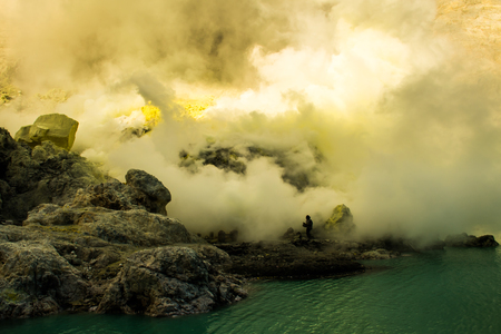 Smoking Kawah Ijen volcano crater with sulphur mine in Indonesiaの写真素材