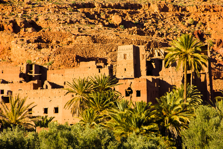 The ancient moroccan town near Tinghir with old kasbahs and high Atlas mountains in background, Tinghir, Morocco in Africaの写真素材