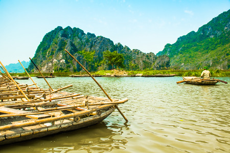Van Long Nature Reserve with boats and beautiful mountains, NinhBinh in Vietnamの写真素材