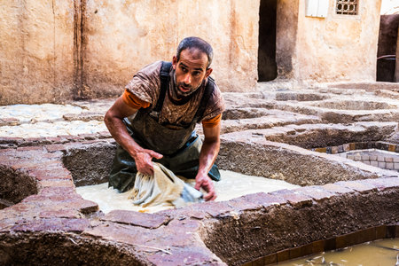 Fez - Morocco - September 29, 2018: Men working in the leather tanneries in Fez, Morocco.のeditorial素材