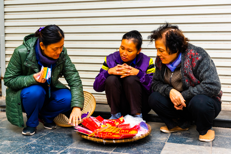 Hanoi, Vietnam - Feb 13, 2018: Street sellers of Hanoi city, Most of the street sellers use bicycle to sell their product like fruits, flowers or other tools needed at home.のeditorial素材