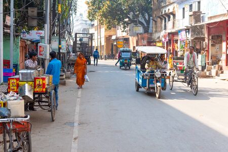 VARANASI, INDIA, MAR 10 2019 -  People movement with the cycles and tuk-tuk vehicles on Varanasi street.のeditorial素材