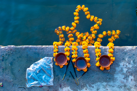 Peoples is kindling lamp with flowers in evening time varanasi, uttar pradesh, Varanasi, Indiaの写真素材