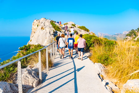 MALLORCA, SPAIN - July 8, 2019: Mirador es Colomer - tourists visit the main viewpoint at Cap de Formentor located on over 200 m high rock. Mallorca, Spainのeditorial素材