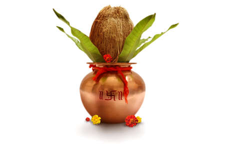 Indian festival akshaya tritiya, Wedding concept : Decorative Copper kalash with coconut and mango leaf with floral decoration on a white background. Essential in Hindu Puja.の写真素材