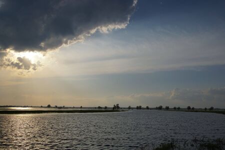 Sunset over spring flooded meadowsの写真素材