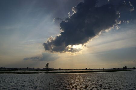 Sunset over spring flooded meadowsの写真素材