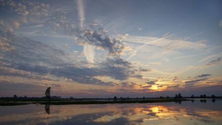 After sunset, dusk over water in the Warta Valleyの写真素材