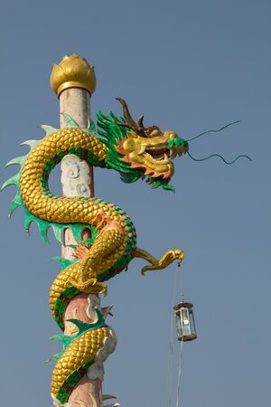 Chinese dragon on the pole in beautiful Chinese shrine.の写真素材
