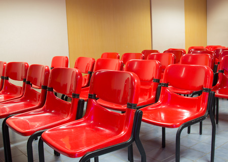 Red chairs in the meeting room for listening sessions.の写真素材