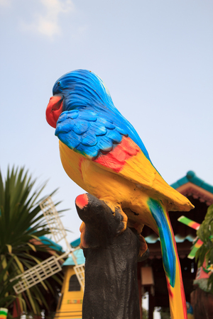 Colorful parrot statue in public park,Thailandの写真素材