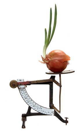 growing onion on old letter scalesの写真素材