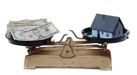 house and dollar notes on scaleの写真素材