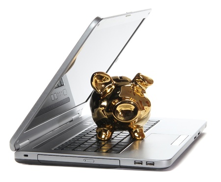 golden piggy bank on notebookの写真素材
