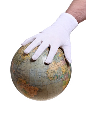 hand with glove holding globeの写真素材