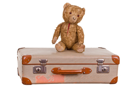 old teddybear sitting on suitcaseの写真素材