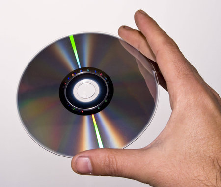A hand showing a CD and your reflexesの写真素材