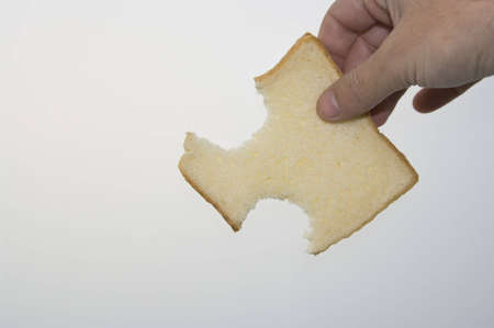 A slice of bread mold with a white backgroundの写真素材