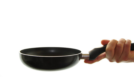 hand of man catching a skillet cookingの写真素材
