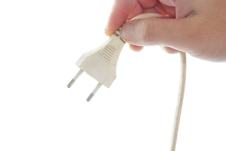 hand of man showing a plug with a white background