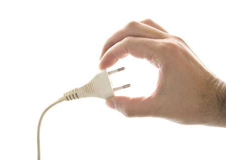 hand of man showing a plug with a white backgroundの写真素材