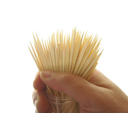 Hand showing some wooden chopsticksの写真素材