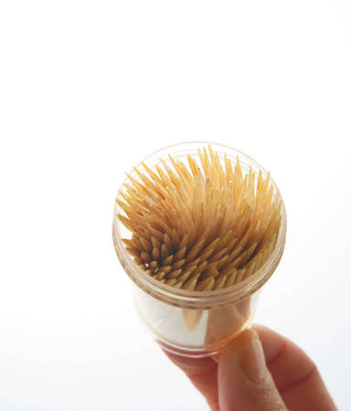 Hand showing some wooden chopsticksの写真素材