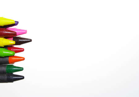 A hand with various colored pencils and white backgroundの写真素材