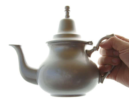 A silver teapot with a white backgroundの写真素材