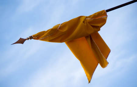 He throws a flag with blue sky backgroundの写真素材