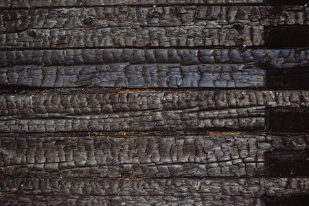 wood charred wall after fire