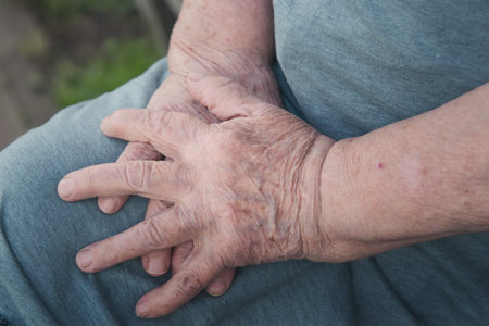 old womans hands on her knee