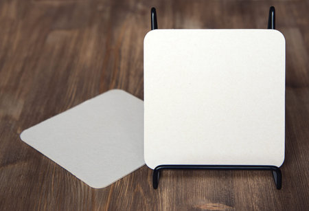 empty blank cardboard beermat on wood mockup