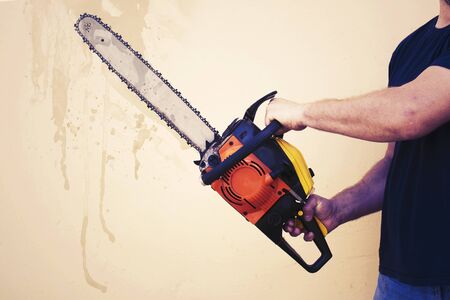 male hand with chainsaw tonedの写真素材